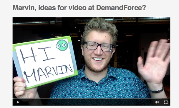 Man in video waving and holding sign