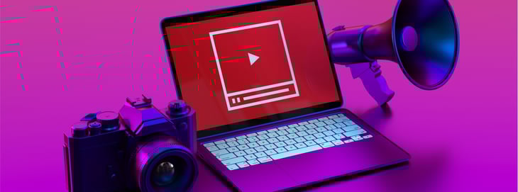 A computer screen displaying the YouTube logo, surrounded by a camera and a megaphone, symbolizing inbound content creation