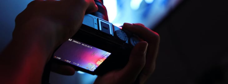 Photographer using a camera to showcase the process of developing a video marketing strategy.