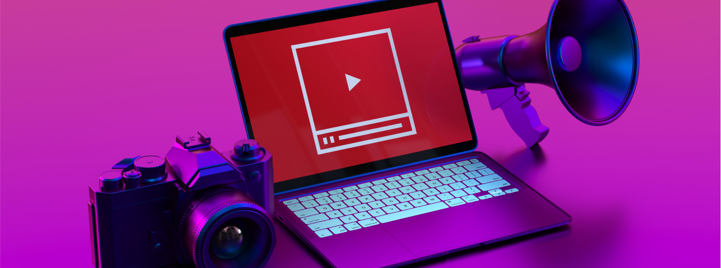 A computer screen displaying the YouTube logo, surrounded by a camera and a megaphone, symbolizing inbound content creation